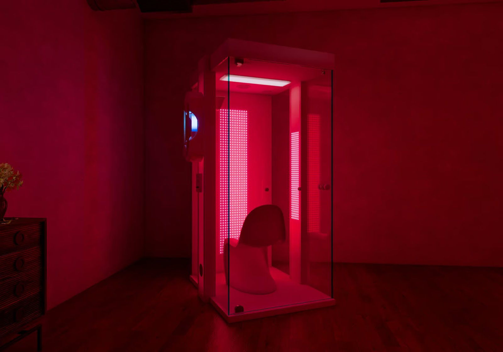 Salz- und Rotlichtkabine mit Glasfront und Sitz in einem rot beleuchteten Raum