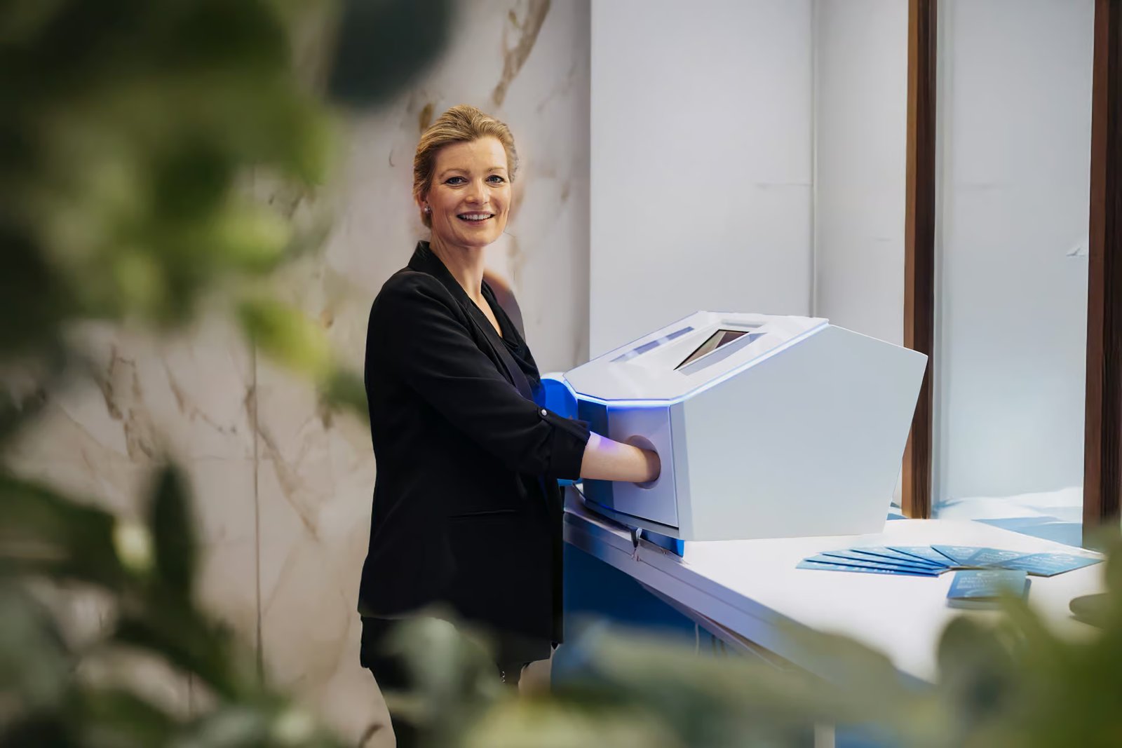 Woman in a blazer trying an application at the device